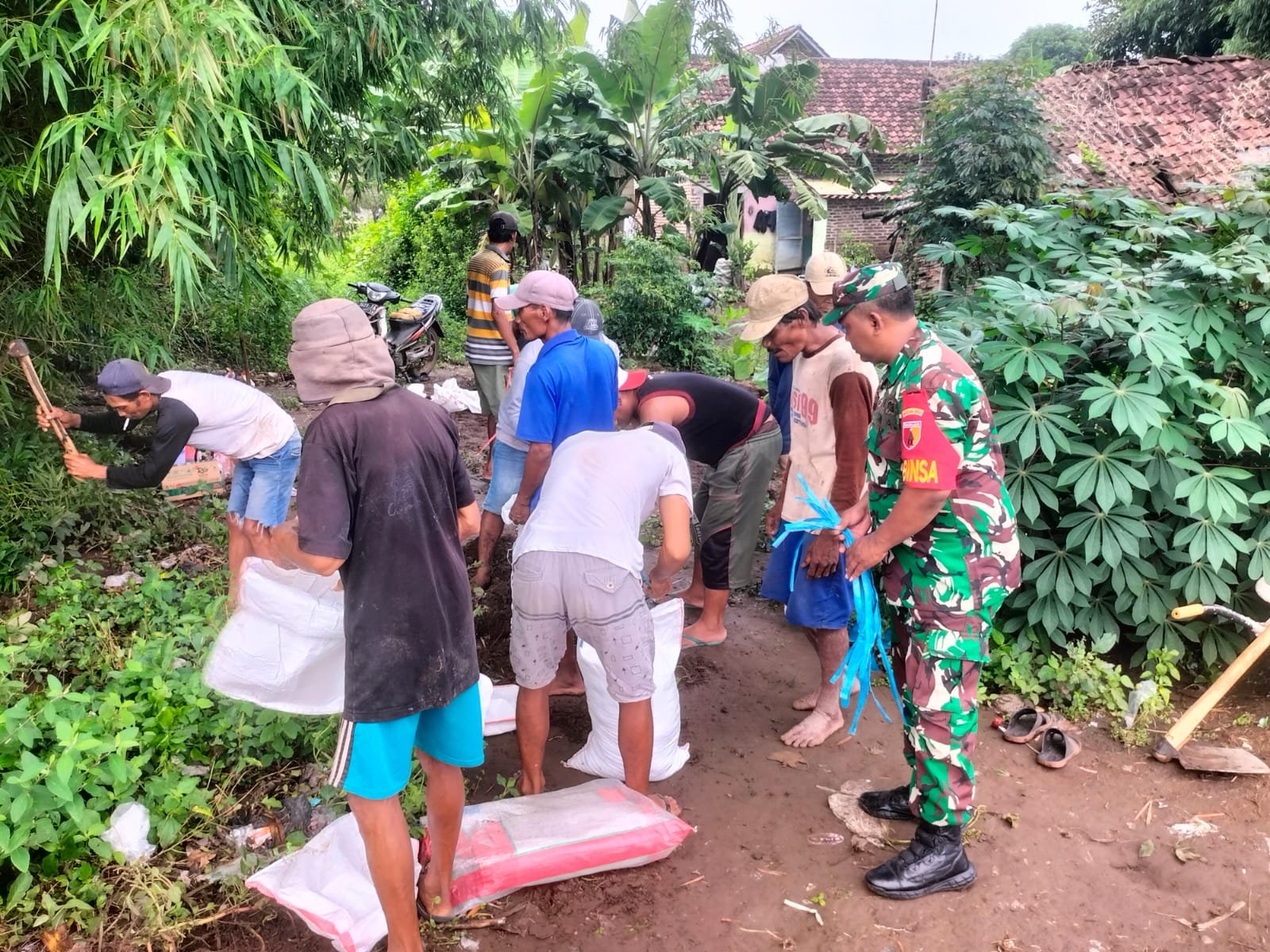Cegah Terjadinya Luapan Air, Babinsa Sumbersono Bersama Masyarakat Perkuat Dinding Tanggul
